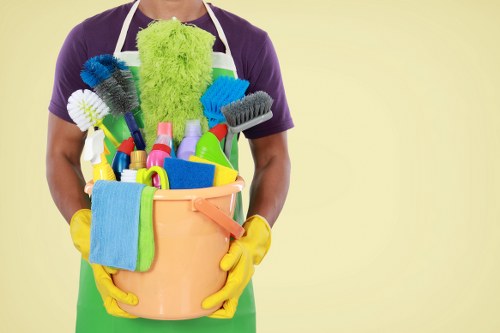 Professional cleaner maintaining shared hallway surfaces